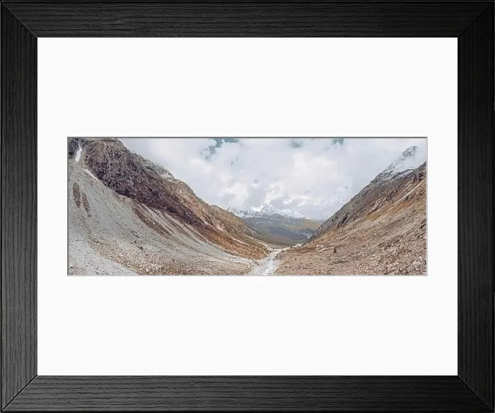 Framed Print : drone view over a desolate receding alpine glacier surrounded by mountains and snow covered rocks and peaks Framed Print : drone view over a desolate receding alpine glacier surrounded by mountains and snow covered rocks and peaks