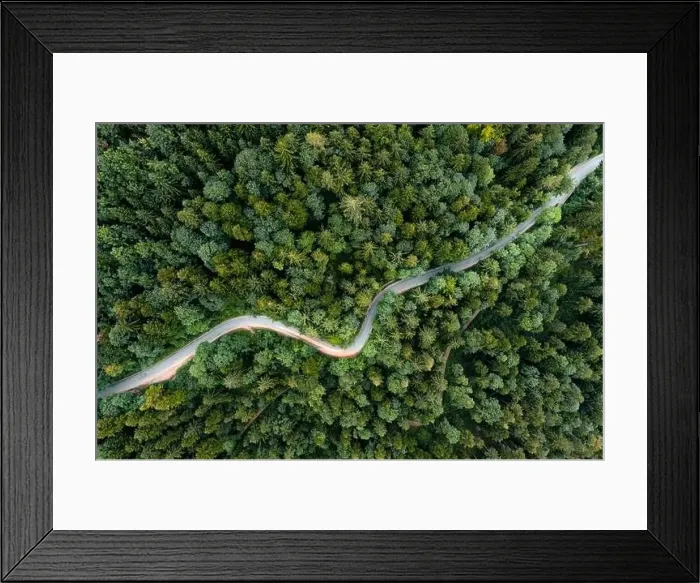 Framed Print : Backlights of a driving car in a curvy road as long exposure from a drone Framed Print : Backlights of a driving car in a curvy road as long exposure from a drone