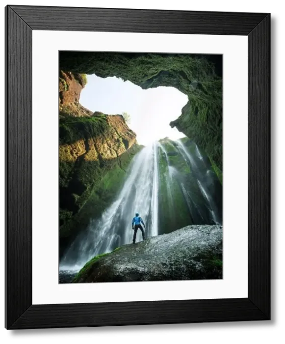 Framed Print : Man in the cave near the Gljufrabui (Gljufrafoss) waterfall Framed Print : Man in the cave near the Gljufrabui (Gljufrafoss) waterfall