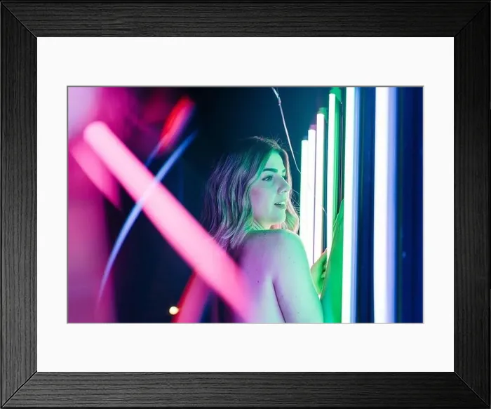 Framed Print : Side view of young dreamy Woman reflecting between rows of glowing neon tubes while looking away Framed Print : Side view of young dreamy Woman reflecting between rows of glowing neon tubes while looking away