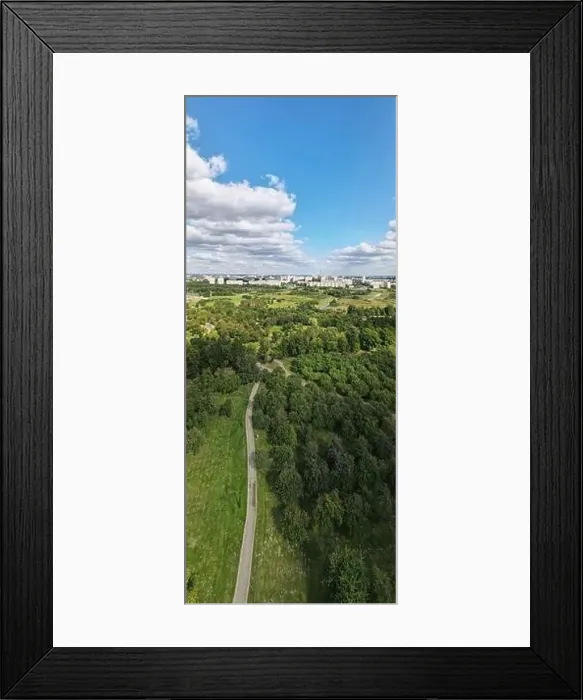 Framed Print : City landscape. Nearby there is a park area. Blue sky with white clouds. Aerial photography of the panorama Framed Print : City landscape. Nearby there is a park area. Blue sky with white clouds. Aerial photography of the panorama