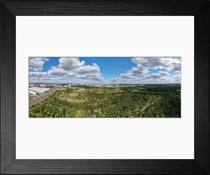 Framed Print : City landscape. Nearby there is a park area. Blue sky with white clouds. Aerial photography of the panorama Framed Print : City landscape. Nearby there is a park area. Blue sky with white clouds. Aerial photography of the panorama