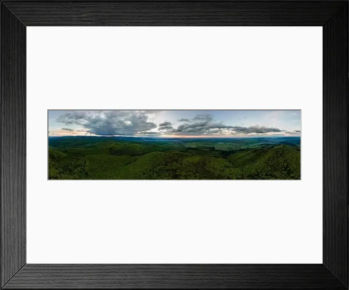 Framed Print : Aerial wide panoramic view of dark mountain hills covered with green mixed pine and lush forest in evening Framed Print : Aerial wide panoramic view of dark mountain hills covered with green mixed pine and lush forest in evening