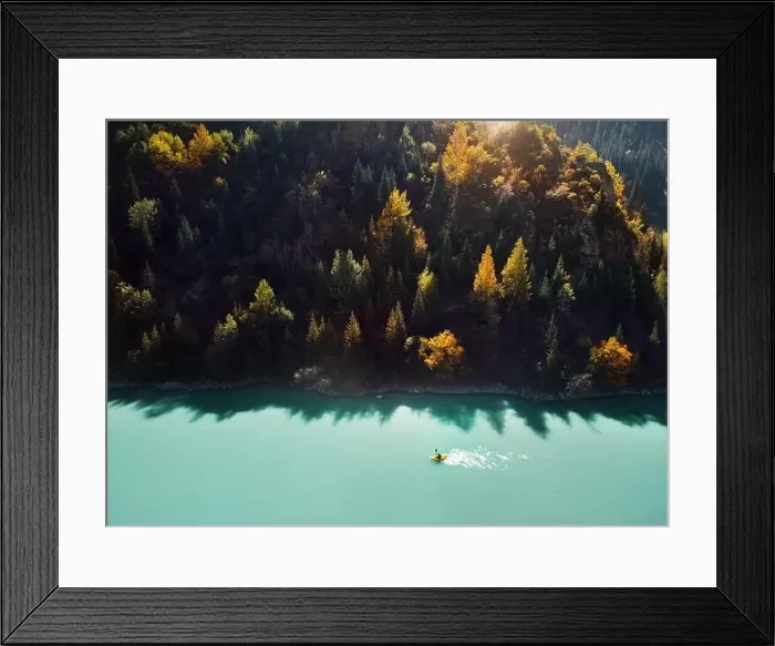 Framed Print : Man is paddling on yellow raft boat in the mountain lake at autumn time. Aerial Drone shot Framed Print : Man is paddling on yellow raft boat in the mountain lake at autumn time. Aerial Drone shot