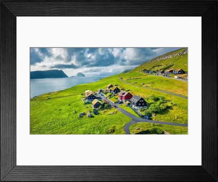 Framed Print : Sunny summer view from flying droneof Kirkjubour village with Hestur Island on background Framed Print : Sunny summer view from flying droneof Kirkjubour village with Hestur Island on background