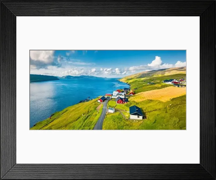 Framed Print : Green summer view from flying droneof Kirkjubour village with Hestur Island on background Framed Print : Green summer view from flying droneof Kirkjubour village with Hestur Island on background