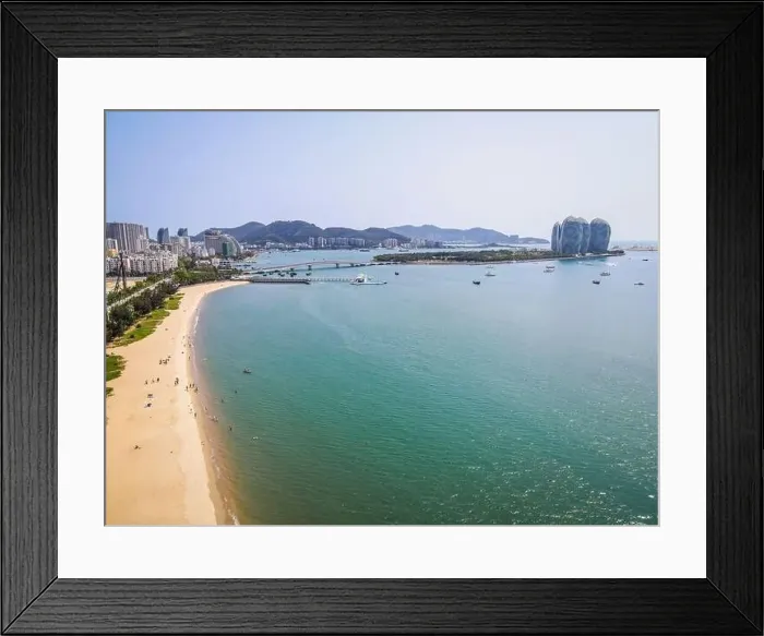 Framed Print : Aerial drone shot of Sanya bay beach with people and Phoenix island in background on Hainan island China Framed Print : Aerial drone shot of Sanya bay beach with people and Phoenix island in background on Hainan island China