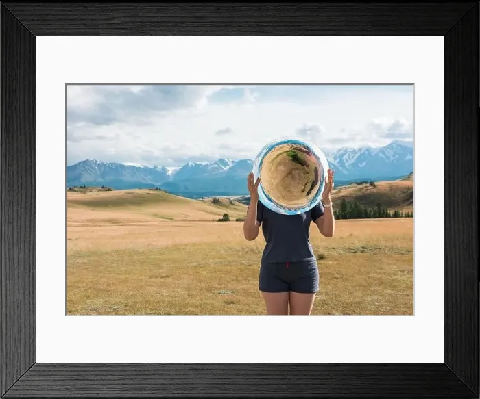 Framed Print : Woman standing in in summer Altai mountains in Kurai steppe and holding circle mirror Framed Print : Woman standing in in summer Altai mountains in Kurai steppe and holding circle mirror