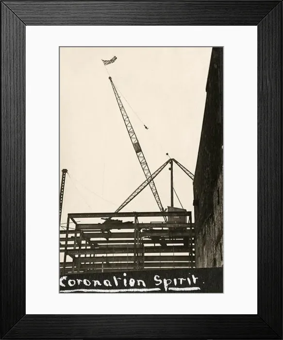 Framed Print : A Union Jack flies from the top of a crane on a construction site to celebrate the Coronation of the British monarch Framed Print : A Union Jack flies from the top of a crane on a construction site to celebrate the Coronation of the British monarch