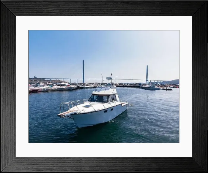Framed Print : A white pleasure boat stands in the bay at sea, in the parking lot. Yacht background of other boats. Photo from a drone Framed Print : A white pleasure boat stands in the bay at sea, in the parking lot. Yacht background of other boats. Photo from a drone