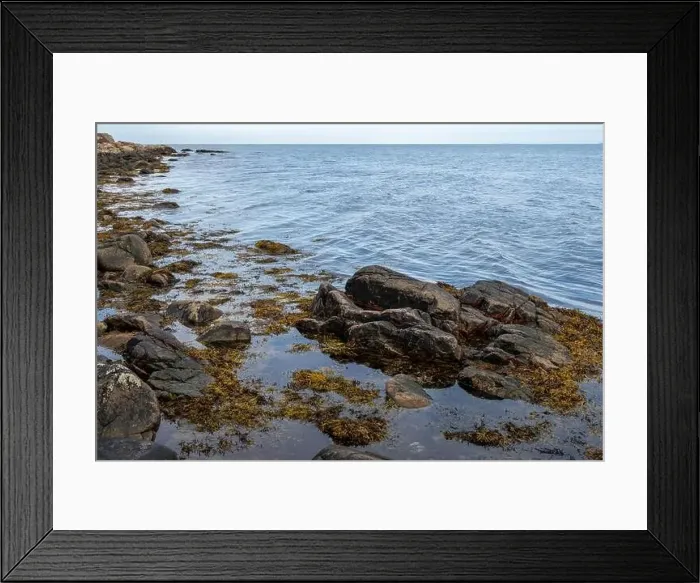 Framed Print : A rocky shoreline with blue water and a blu sky in the background. Picture from Skalderviken, southern Sweden Framed Print : A rocky shoreline with blue water and a blu sky in the background. Picture from Skalderviken, southern Sweden