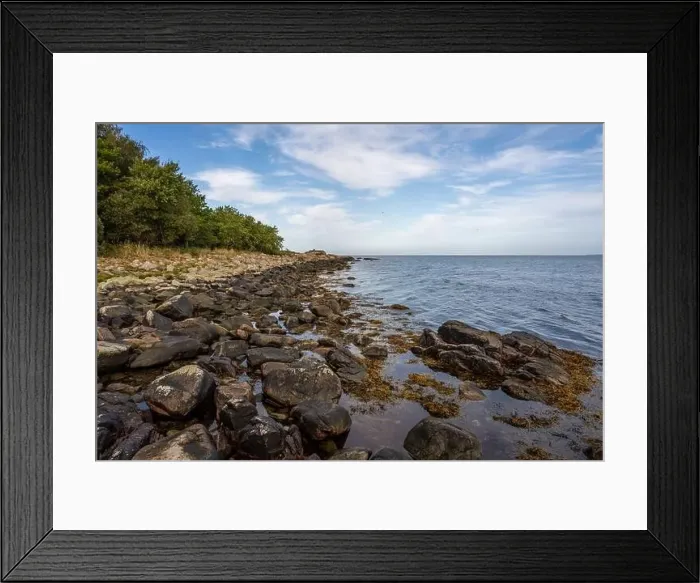 Framed Print : A rocky shoreline with blue water and a blu sky in the background. Picture from Skalderviken, southern Sweden Framed Print : A rocky shoreline with blue water and a blu sky in the background. Picture from Skalderviken, southern Sweden
