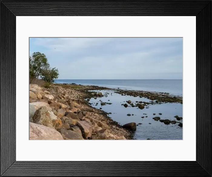 Framed Print : A rocky shoreline with blue water and a blu sky in the background. Picture from Skalderviken, southern Sweden Framed Print : A rocky shoreline with blue water and a blu sky in the background. Picture from Skalderviken, southern Sweden