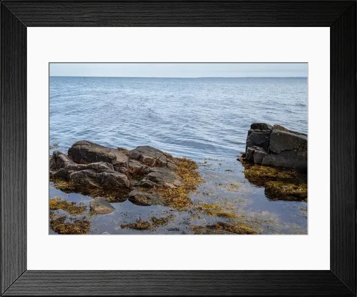Framed Print : A rocky shoreline with blue water and a blu sky in the background. Picture from Skalderviken, southern Sweden Framed Print : A rocky shoreline with blue water and a blu sky in the background. Picture from Skalderviken, southern Sweden