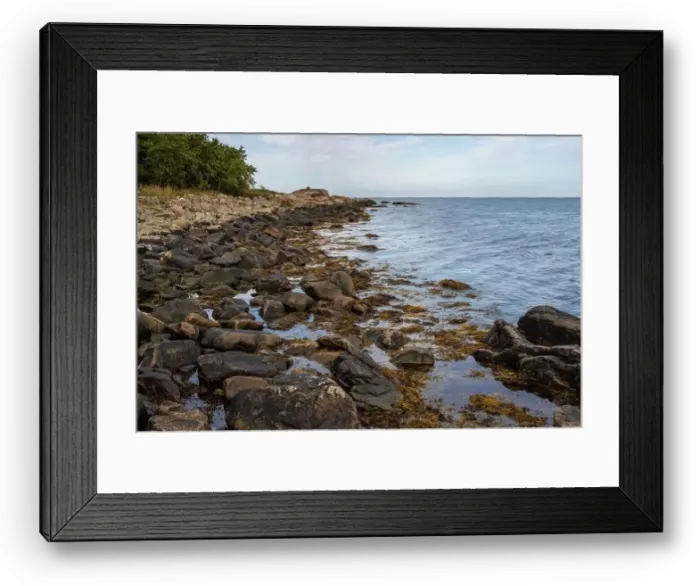 Framed Print : A rocky shoreline with blue water and a blu sky in the background. Picture from Skalderviken, southern Sweden Framed Print : A rocky shoreline with blue water and a blu sky in the background. Picture from Skalderviken, southern Sweden