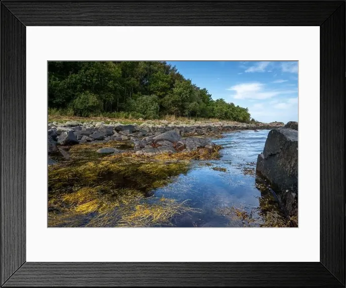 Framed Print : A rocky shoreline with blue water and a blu sky in the background. Picture from Skalderviken, southern Sweden Framed Print : A rocky shoreline with blue water and a blu sky in the background. Picture from Skalderviken, southern Sweden