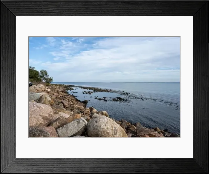 Framed Print : A rocky shoreline with blue water and a blu sky in the background. Picture from Skalderviken, southern Sweden Framed Print : A rocky shoreline with blue water and a blu sky in the background. Picture from Skalderviken, southern Sweden