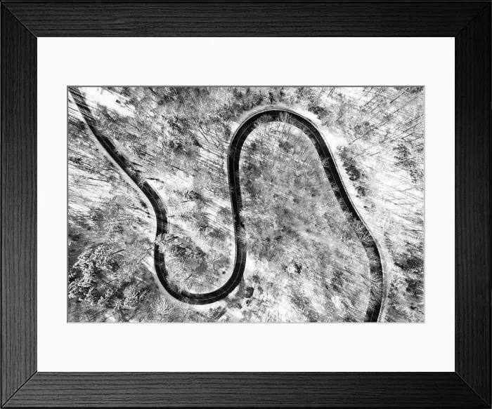 Framed Print : Clear view at a country road from above in the winter season with much snow as top down shot by a drone Framed Print : Clear view at a country road from above in the winter season with much snow as top down shot by a drone