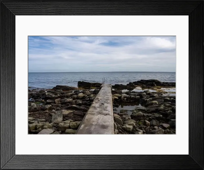 Framed Print : Rocky shoreline with a concrete jetty Framed Print : Rocky shoreline with a concrete jetty