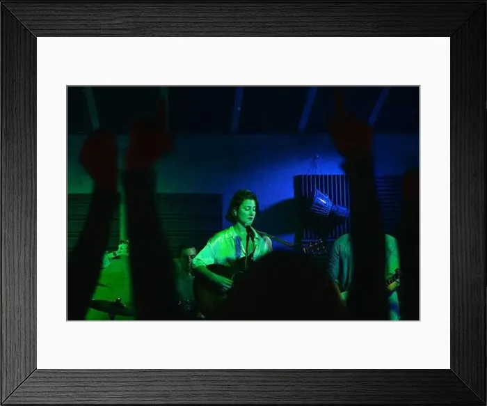 Framed Print : Group of people in casual clothes playing guitars and drums while Woman singing Framed Print : Group of people in casual clothes playing guitars and drums while Woman singing