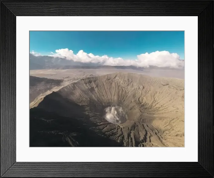 Framed Print : Cinematic shot aerial view of Mount Bromo crater with active volcano smoke in East Java Framed Print : Cinematic shot aerial view of Mount Bromo crater with active volcano smoke in East Java
