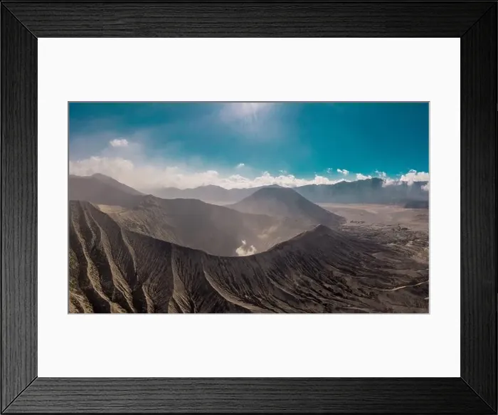 Framed Print : Cinematic shot aerial view of Mount Bromo crater with active volcano smoke in East Java Framed Print : Cinematic shot aerial view of Mount Bromo crater with active volcano smoke in East Java