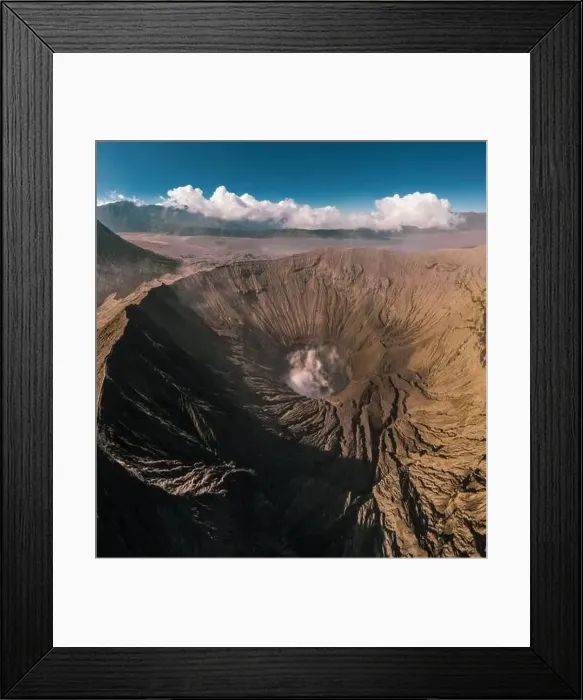 Framed Print : Cinematic shot aerial view of Mount Bromo crater with active volcano smoke in East Java Framed Print : Cinematic shot aerial view of Mount Bromo crater with active volcano smoke in East Java