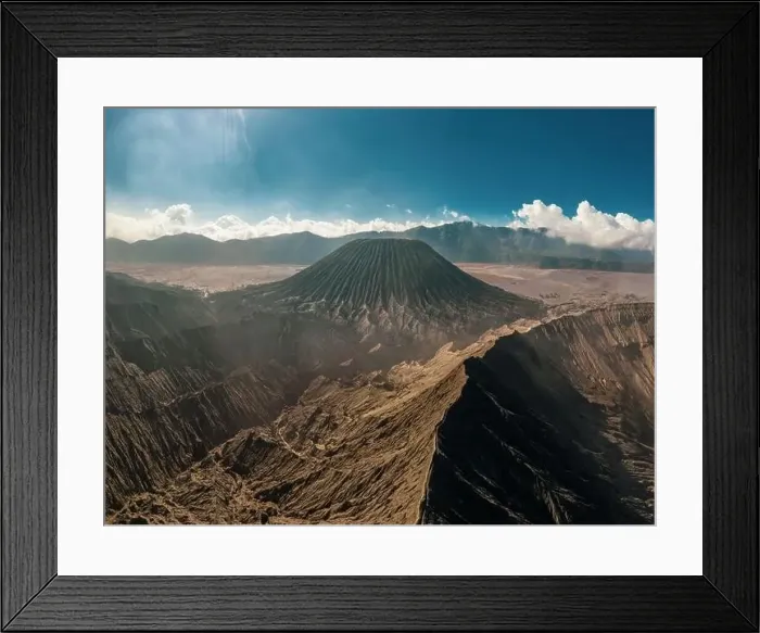 Framed Print : Cinematic shot aerial view of Mount Bromo crater edge with active volcano smoke in East Java Framed Print : Cinematic shot aerial view of Mount Bromo crater edge with active volcano smoke in East Java
