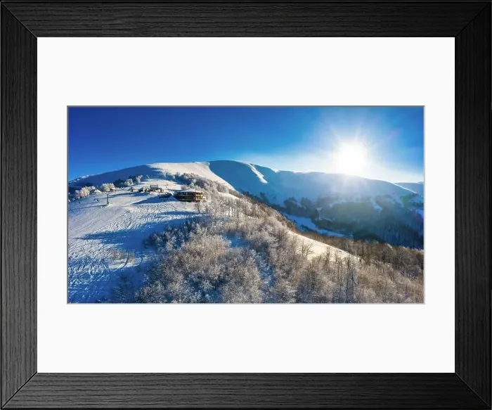 Framed Print : Picturesque winter panorama of mountain hills covered with snow and fir trees on a sunny clear day with the sun Framed Print : Picturesque winter panorama of mountain hills covered with snow and fir trees on a sunny clear day with the sun