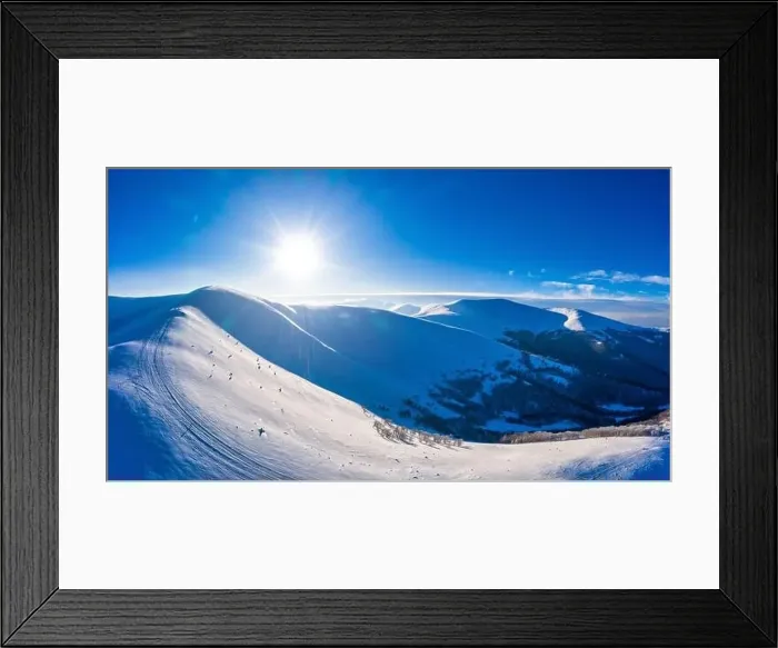 Framed Print : Magical winter panorama of beautiful snowy slopes at a ski resort in Europe on a sunny Framed Print : Magical winter panorama of beautiful snowy slopes at a ski resort in Europe on a sunny