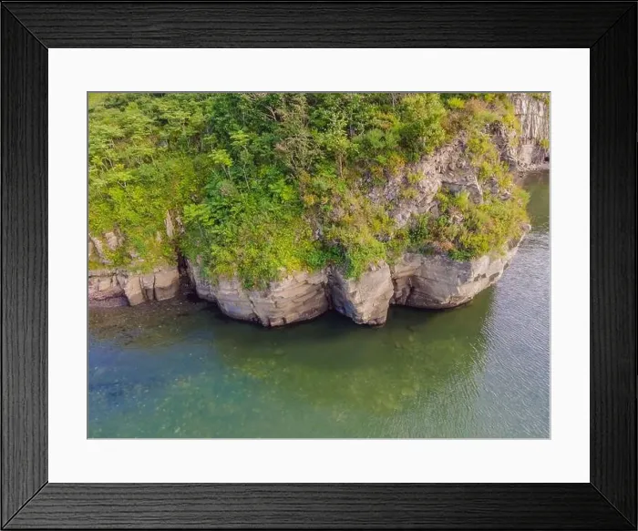 Framed Print : Aerial view of a slide turn from a drone on the view of calm turquoise sea water and rocks Framed Print : Aerial view of a slide turn from a drone on the view of calm turquoise sea water and rocks