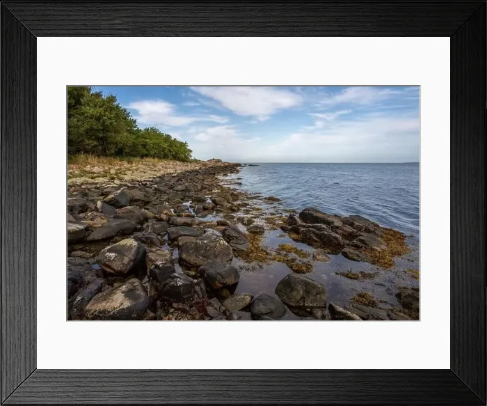Framed Print : A rocky shoreline with blue water and a blu sky in the background. Picture from Skalderviken, southern Sweden Framed Print : A rocky shoreline with blue water and a blu sky in the background. Picture from Skalderviken, southern Sweden