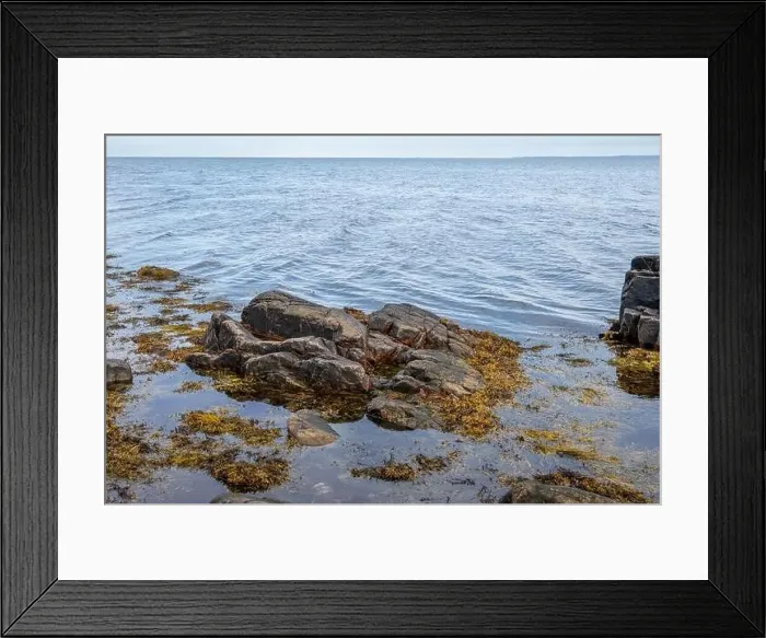 Framed Print : A rocky shoreline with blue water and a blu sky in the background. Picture from Skalderviken, southern Sweden Framed Print : A rocky shoreline with blue water and a blu sky in the background. Picture from Skalderviken, southern Sweden