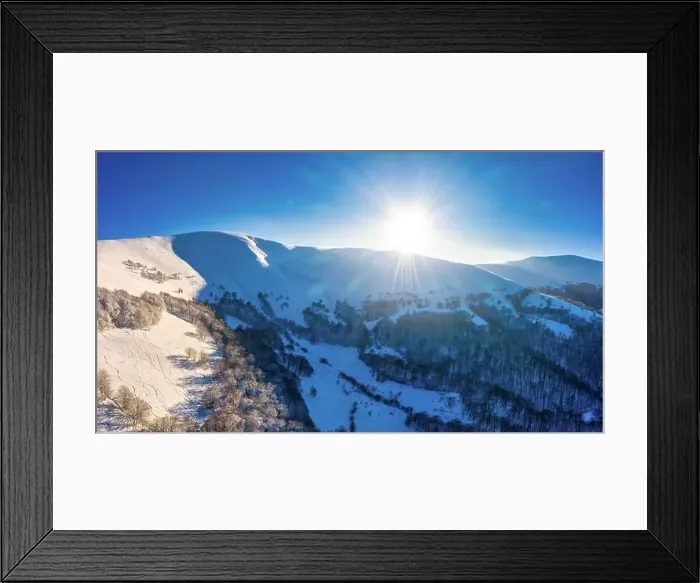 Framed Print : Magical winter panorama of beautiful snowy slopes at a ski resort in Europe on a sunny Framed Print : Magical winter panorama of beautiful snowy slopes at a ski resort in Europe on a sunny