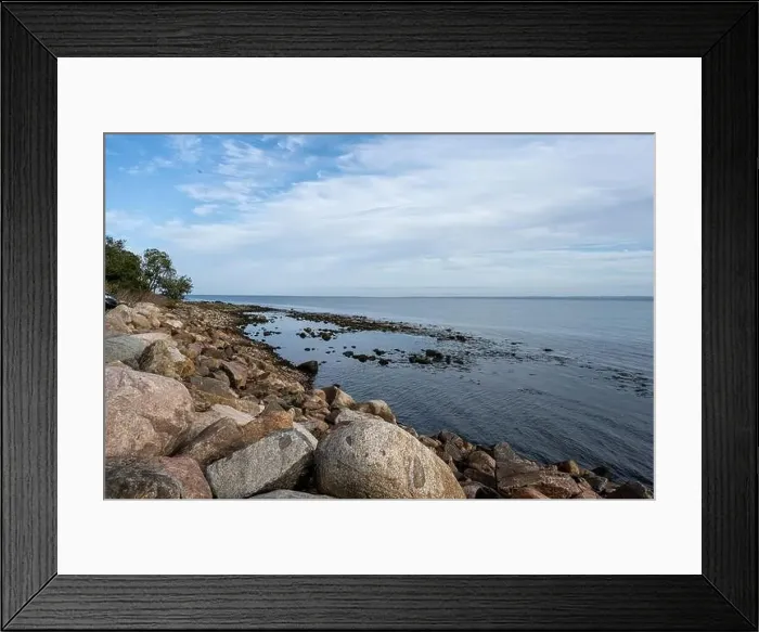 Framed Print : A rocky shoreline with blue water and a blu sky in the background. Picture from Skalderviken, southern Sweden Framed Print : A rocky shoreline with blue water and a blu sky in the background. Picture from Skalderviken, southern Sweden