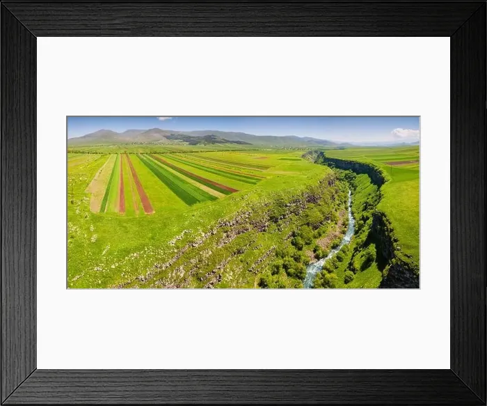 Framed Print : Panoramic aerial view of agricultural fields sown with crops and river in deep canyon