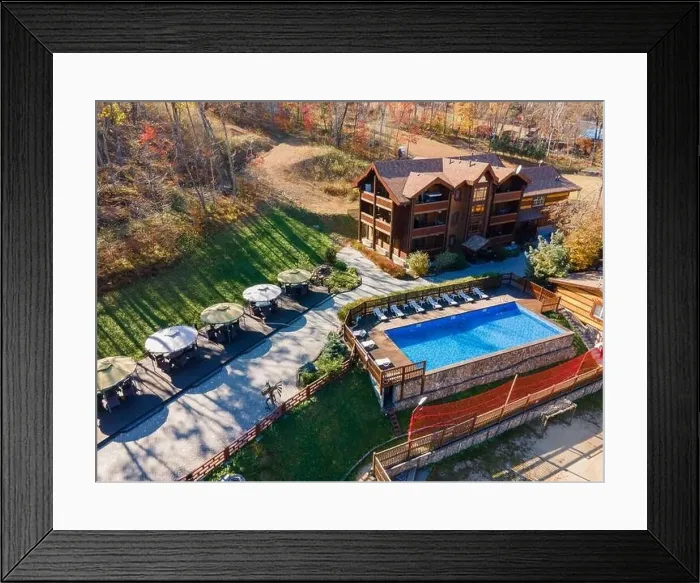 Framed Print : Country recreation center located in the woods with a large blue pool, sun loungers and tables. Photo from the drone