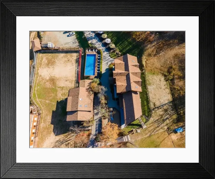 Framed Print : Country recreation center located in the woods with a large blue pool, sun loungers and tables. Photo from the drone Framed Print : Country recreation center located in the woods with a large blue pool, sun loungers and tables. Photo from the drone