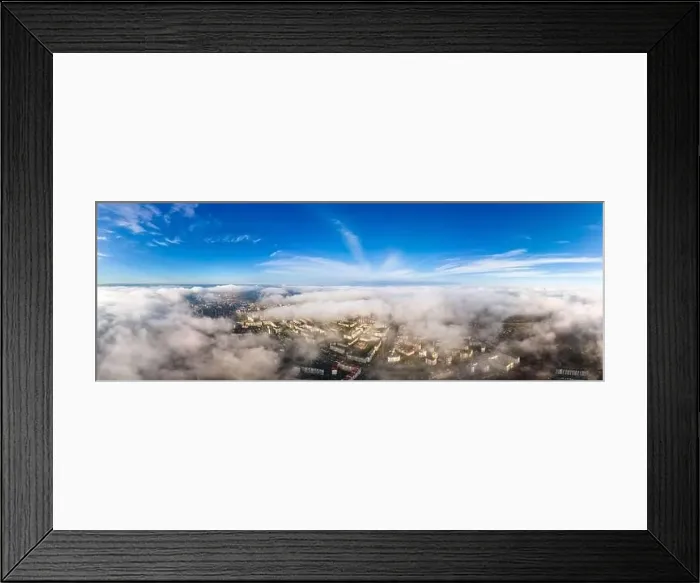Framed Print : Top aerial view of fluffy white clouds over modern city with high rise buildings Framed Print : Top aerial view of fluffy white clouds over modern city with high rise buildings