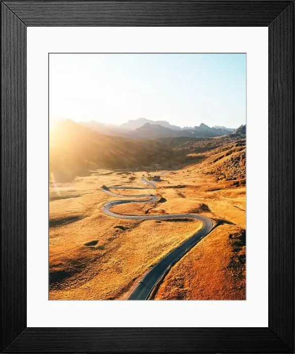 Framed Print : Picturesque aerial view on winding road in autumn mountain valley at sunset Framed Print : Picturesque aerial view on winding road in autumn mountain valley at sunset