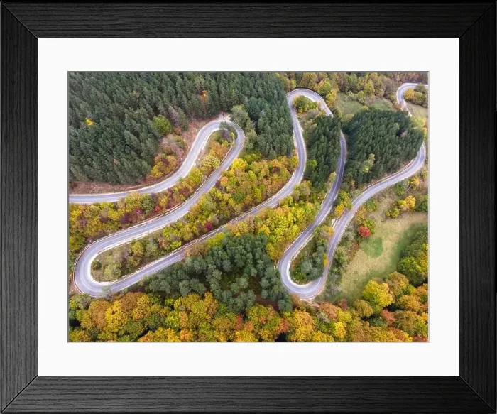 Framed Print : Stunning aerial view of road with curves crossing dense forest in autumn colors in Bulgaria. High quality photo Framed Print : Stunning aerial view of road with curves crossing dense forest in autumn colors in Bulgaria. High quality photo