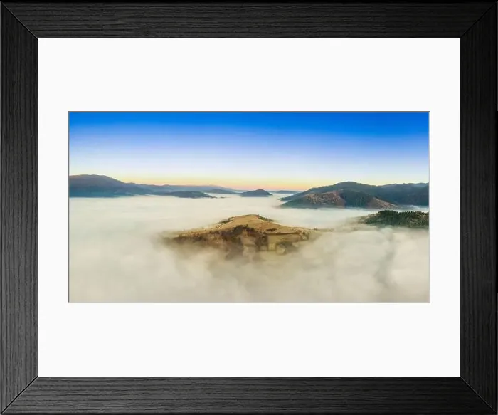 Framed Print : Wonderful autumn landscape in the mountains at dawn. Drone view of the autumn forest and low clouds