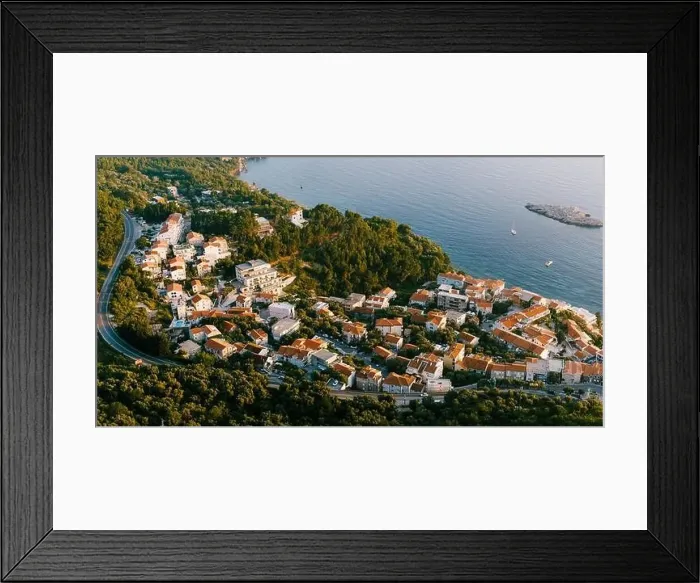 Framed Print : Aerial view of the houses of the seaside town at the foot of the mountains Framed Print : Aerial view of the houses of the seaside town at the foot of the mountains