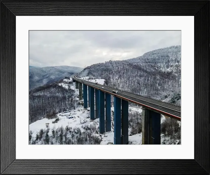 Framed Print : Amazing aerial view of a road. Stunning snow landscape with river and trees Framed Print : Amazing aerial view of a road. Stunning snow landscape with river and trees