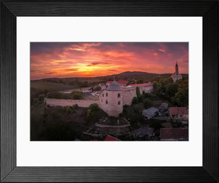 Framed Print : Aerial sunset shot of Pecsvarad fortified church and castle with tower, gate on a hilltop in Baranya county Hungary Framed Print : Aerial sunset shot of Pecsvarad fortified church and castle with tower, gate on a hilltop in Baranya county Hungary