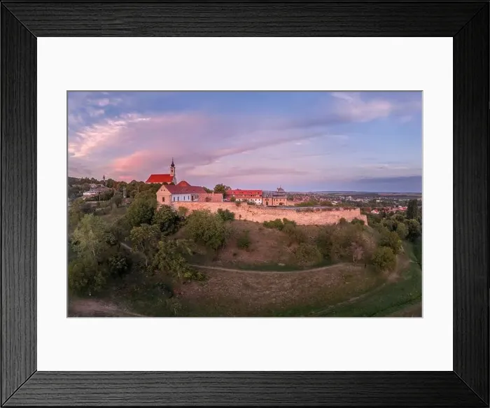 Framed Print : Aerial sunset shot of Pecsvarad fortified church and castle with tower, gate on a hilltop in Baranya county Hungary Framed Print : Aerial sunset shot of Pecsvarad fortified church and castle with tower, gate on a hilltop in Baranya county Hungary