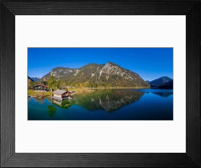 Framed Print : aerial view to boathouse at lake plansee in fall mood with great reflections in clear blue water Framed Print : aerial view to boathouse at lake plansee in fall mood with great reflections in clear blue water