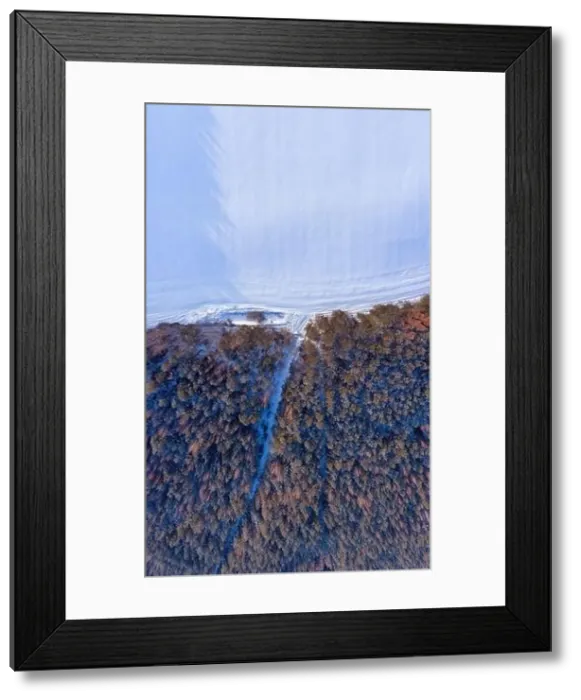 Framed Print : Aerial winter landscape. Snowy frost covered forest and field with tracks in snow
