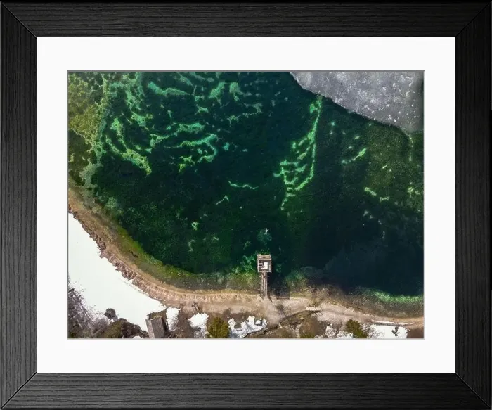 Framed Print : Top down view of person swimming in icy man-made lake in Slovenia. Snowy lakeside Framed Print : Top down view of person swimming in icy man-made lake in Slovenia. Snowy lakeside