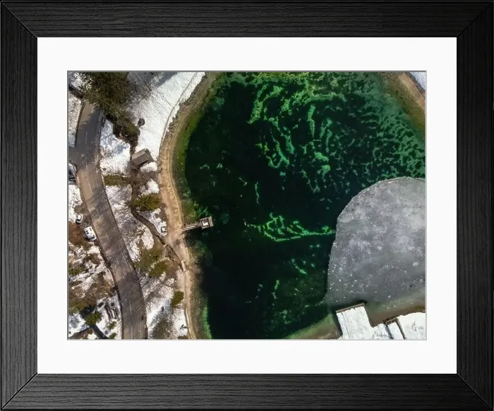 Framed Print : Aerial view of person swimming in icy man-made lake in Slovenia. Snowy lakeside Framed Print : Aerial view of person swimming in icy man-made lake in Slovenia. Snowy lakeside